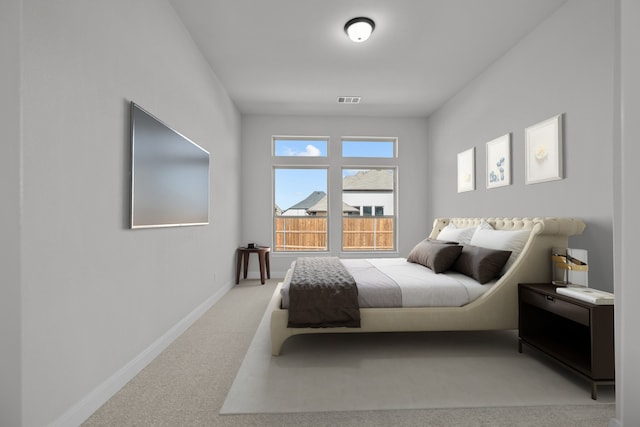 carpeted bedroom with visible vents and baseboards