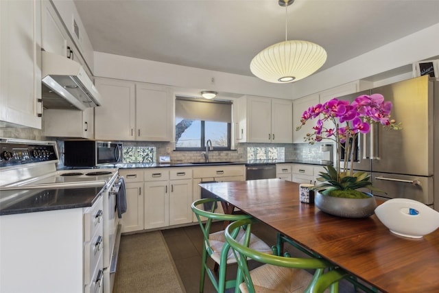 kitchen featuring white cabinets, decorative backsplash, sink, and appliances with stainless steel finishes