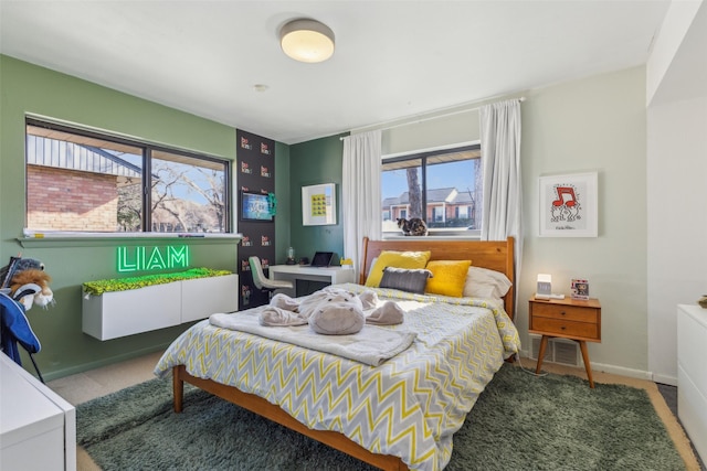 bedroom featuring carpet flooring and multiple windows