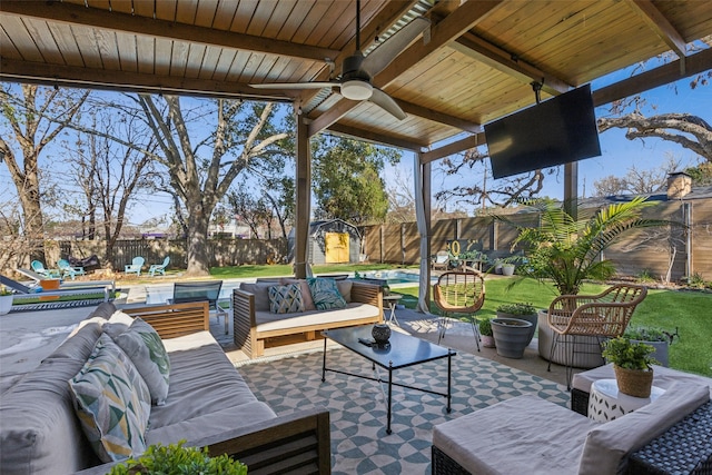 view of patio featuring outdoor lounge area, ceiling fan, a storage shed, and a swimming pool