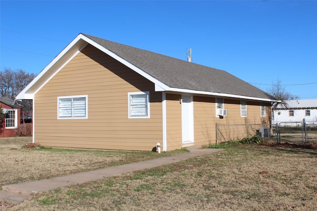 950 N Munday Ave, Munday, TX 76371 - view of side of home with a yard, cooling unit, and central air condition unit