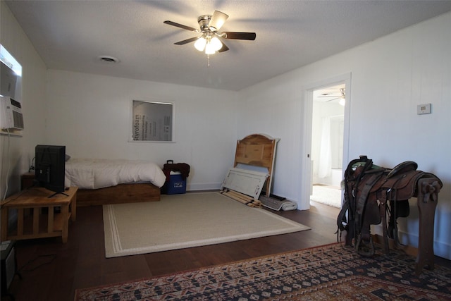 950 N Munday Ave, Munday, TX 76371 - bedroom featuring a textured ceiling, dark wood-type flooring, and ceiling fan
