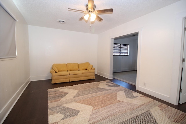 950 N Munday Ave, Munday, TX 76371 - unfurnished room featuring ceiling fan, dark hardwood / wood-style floors, and a textured ceiling