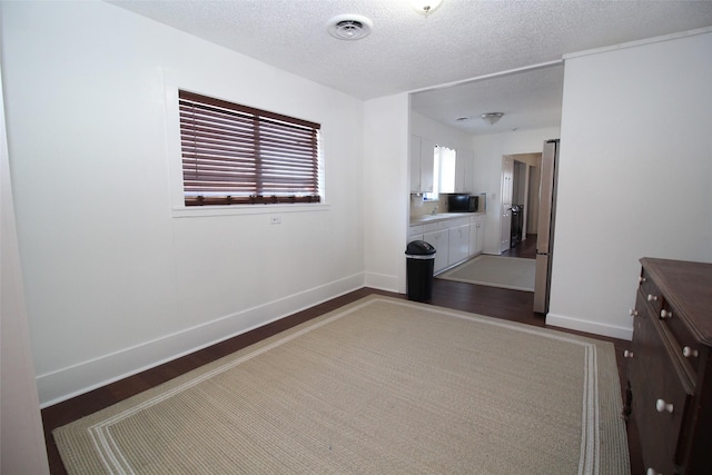 950 N Munday Ave, Munday, TX 76371 - interior space featuring hardwood / wood-style floors and a textured ceiling
