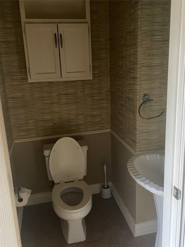 bathroom with tile patterned floors and toilet