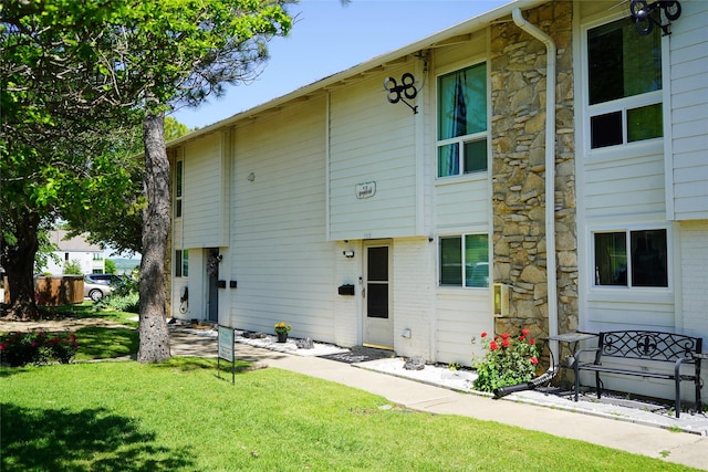 rear view of property with a lawn