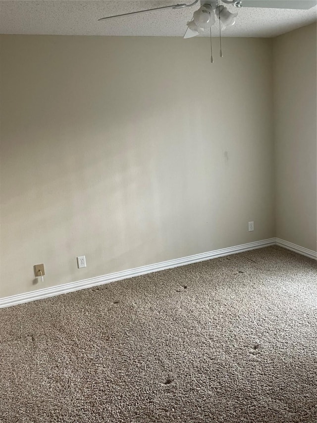 unfurnished room featuring ceiling fan, carpet, and a textured ceiling