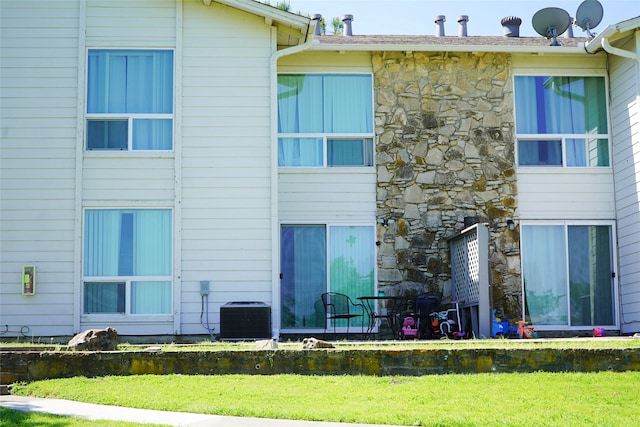 rear view of house featuring cooling unit