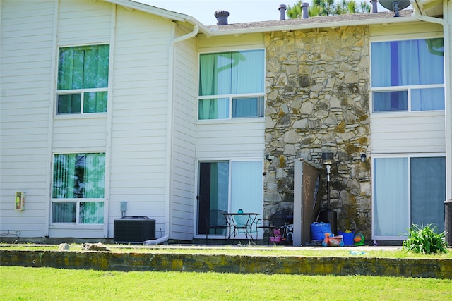 back of house featuring central air condition unit