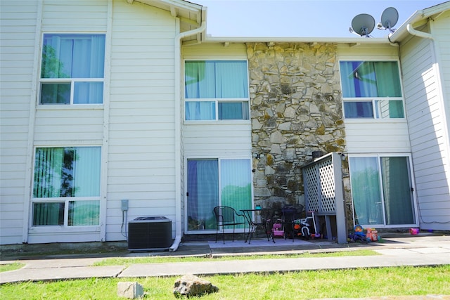 back of house featuring cooling unit