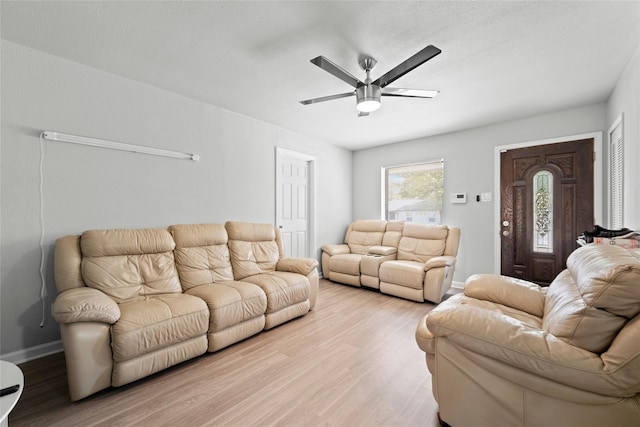 living room featuring ceiling fan and light wood-type flooring