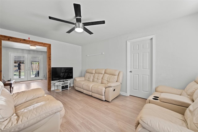 living room with light hardwood / wood-style flooring, french doors, and ceiling fan