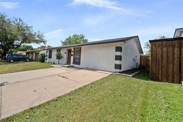 ranch-style house with a patio and a front lawn