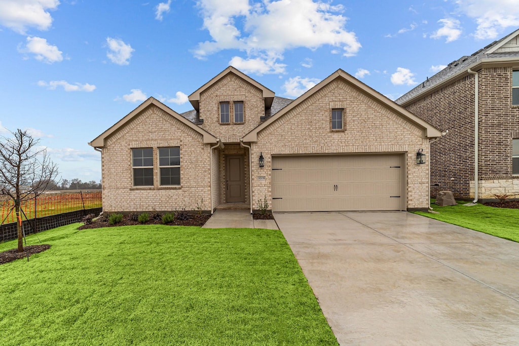 view of front facade with a garage and a front yard