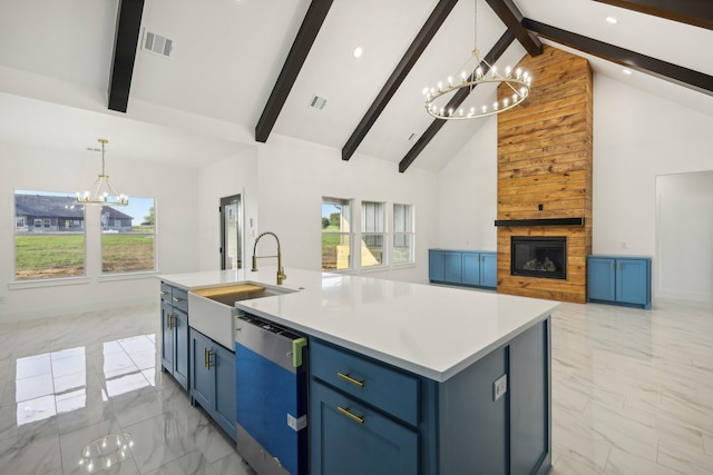 kitchen featuring sink, stainless steel dishwasher, a notable chandelier, blue cabinetry, and a center island with sink