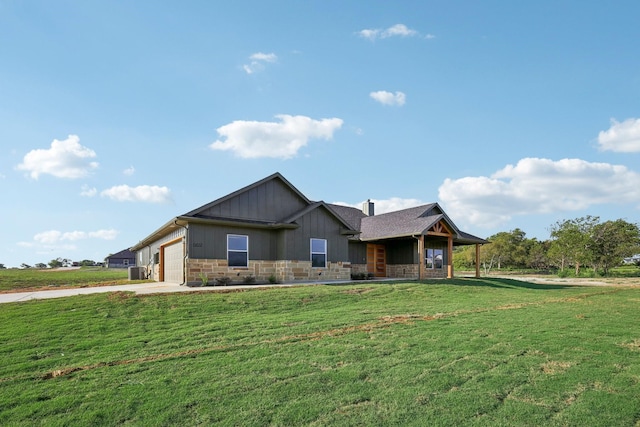 view of front of property with a front yard and a garage