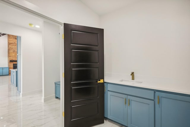 interior space featuring vaulted ceiling and sink