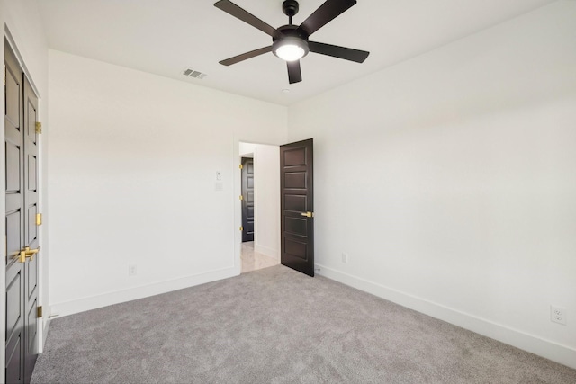 unfurnished bedroom with light colored carpet and ceiling fan