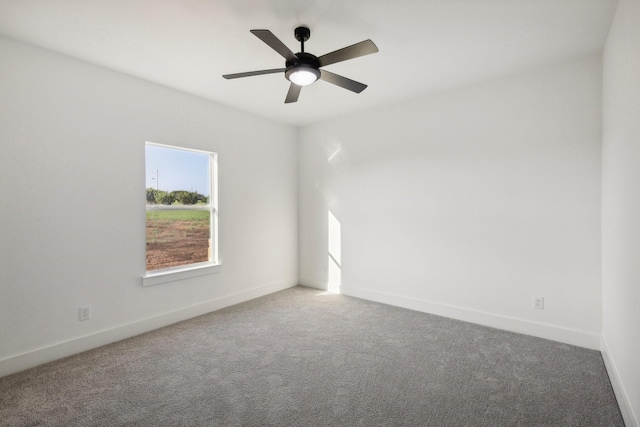 empty room with ceiling fan and carpet