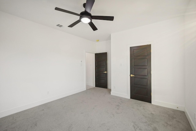 spare room featuring light carpet and ceiling fan