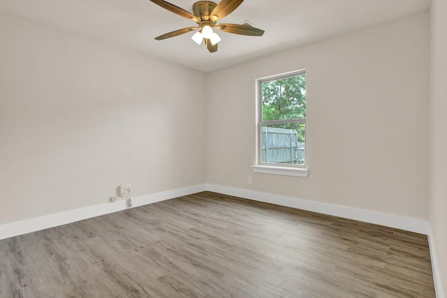 spare room featuring hardwood / wood-style floors and ceiling fan