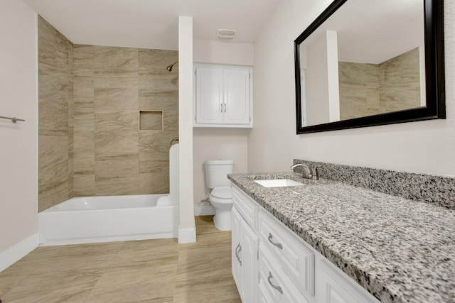 full bathroom featuring toilet, vanity, and tub / shower combination