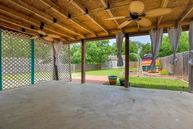 view of patio featuring ceiling fan and a storage shed