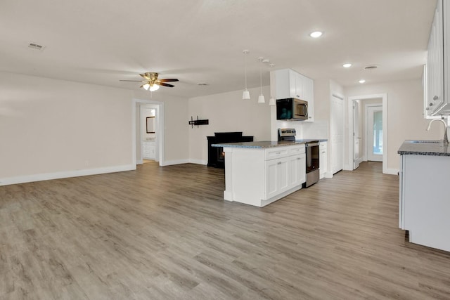 kitchen with ceiling fan, sink, hanging light fixtures, white cabinets, and appliances with stainless steel finishes