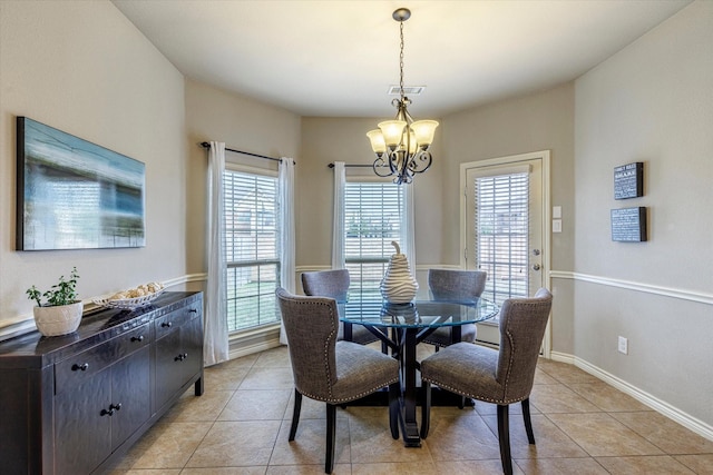 tiled dining area featuring a chandelier