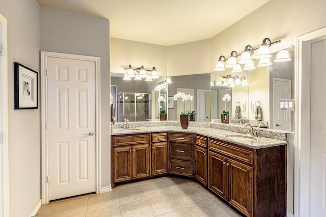 bathroom featuring tile patterned flooring, vanity, and a shower with shower door