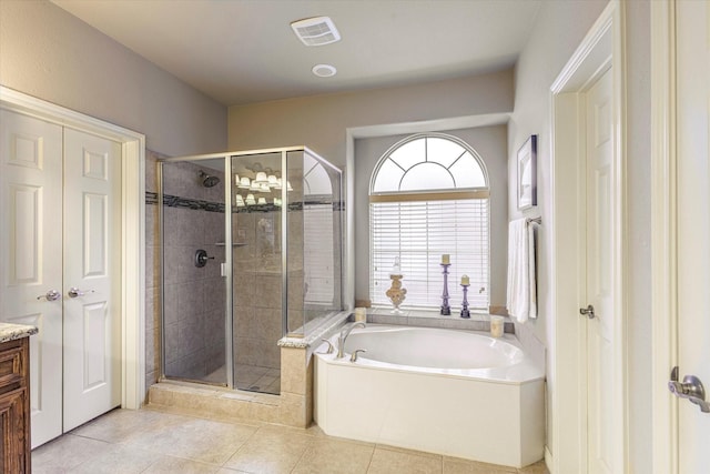 bathroom featuring vanity, shower with separate bathtub, and tile patterned flooring