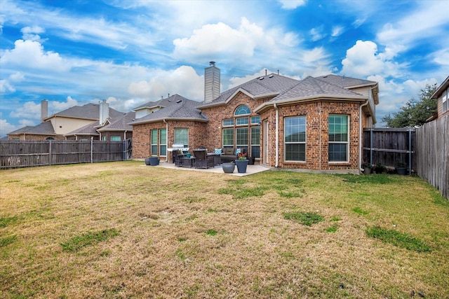 back of house with a lawn and a patio area