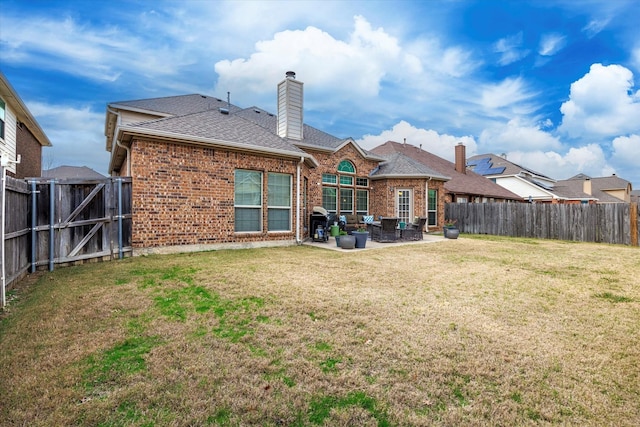 rear view of house with a patio area and a lawn