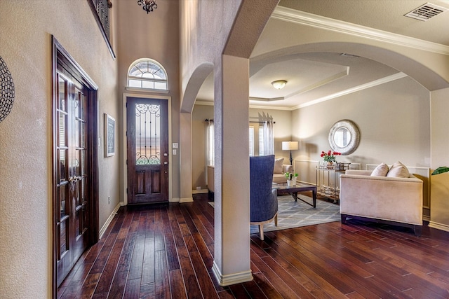 foyer featuring crown molding and wood-type flooring