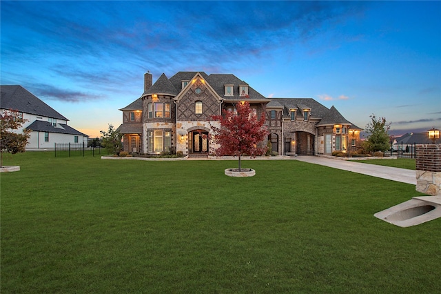 french provincial home with a lawn