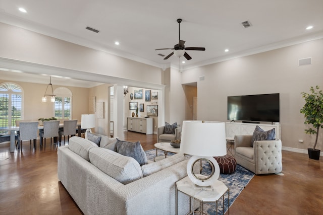 living room featuring ceiling fan with notable chandelier and ornamental molding