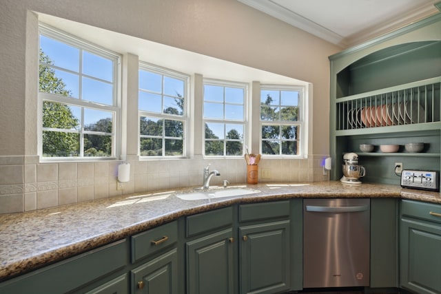 kitchen featuring sink, green cabinets, light stone counters, stainless steel dishwasher, and decorative backsplash