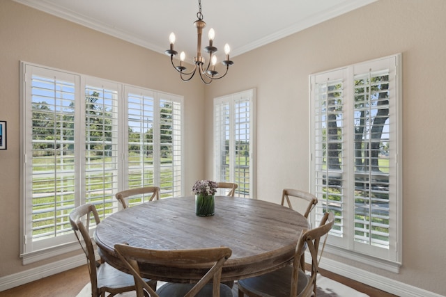 dining space featuring a notable chandelier, plenty of natural light, and crown molding