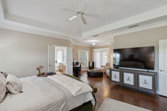 bedroom with connected bathroom, a tray ceiling, ceiling fan, and crown molding