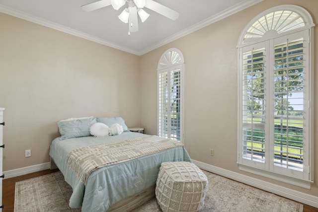 bedroom featuring ceiling fan, crown molding, and hardwood / wood-style flooring