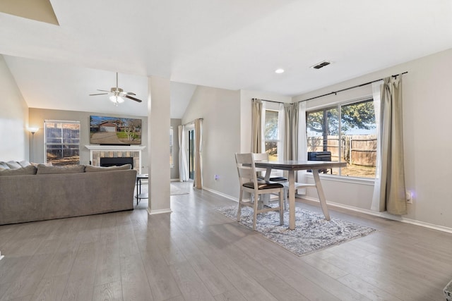 dining area with vaulted ceiling, ceiling fan, and light hardwood / wood-style floors