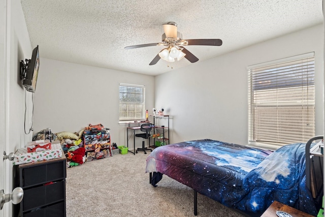 carpeted bedroom featuring ceiling fan and a textured ceiling