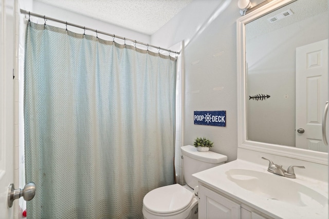 bathroom featuring vanity, a shower with shower curtain, a textured ceiling, and toilet