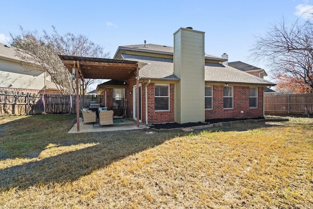 back of property featuring a pergola, a lawn, and a patio area