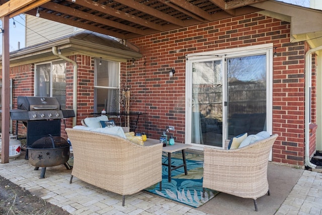 view of patio / terrace with a grill and a fire pit