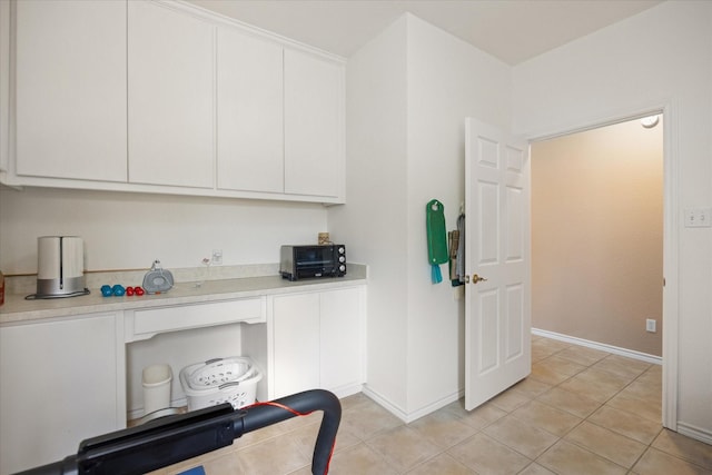 kitchen featuring white cabinets and light tile patterned floors