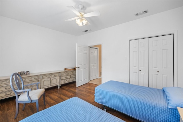 bedroom with a closet, dark hardwood / wood-style floors, and ceiling fan