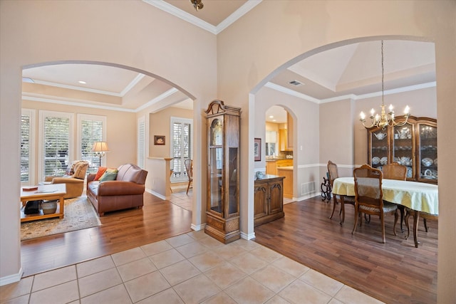 interior space with ornamental molding and a tray ceiling