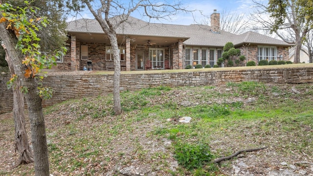 rear view of property featuring ceiling fan