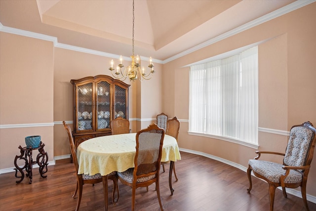 dining area with a chandelier, dark hardwood / wood-style floors, and a tray ceiling